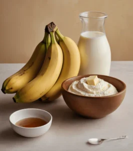 Ingredients for banana bread including ripe bananas, milk, butter, and honey on a kitchen counter.