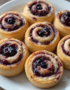 Blueberry Danish pastries with flaky layers and sweet blueberry filling.