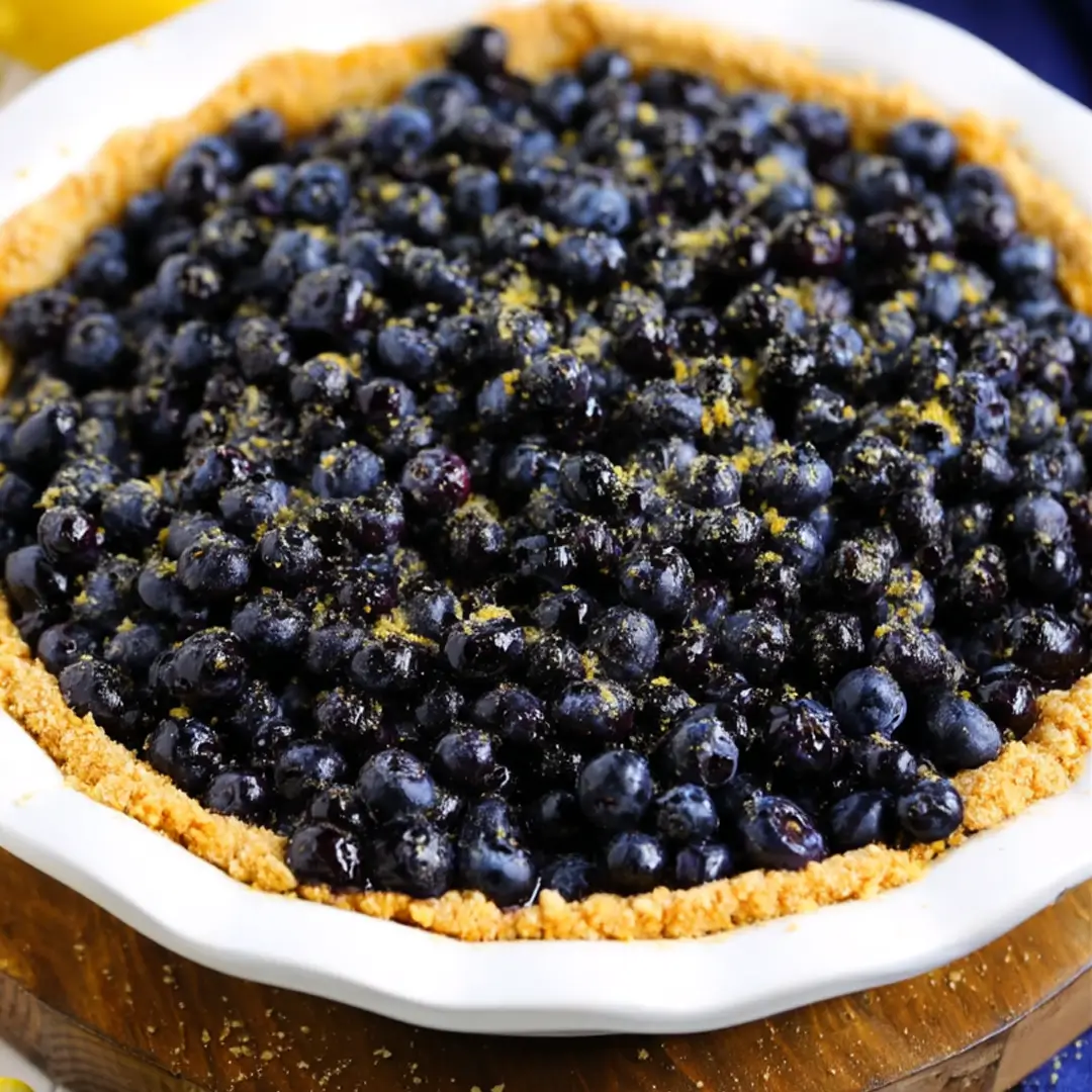 Lemon blueberry pie filled with fresh blueberries in a graham cracker crust