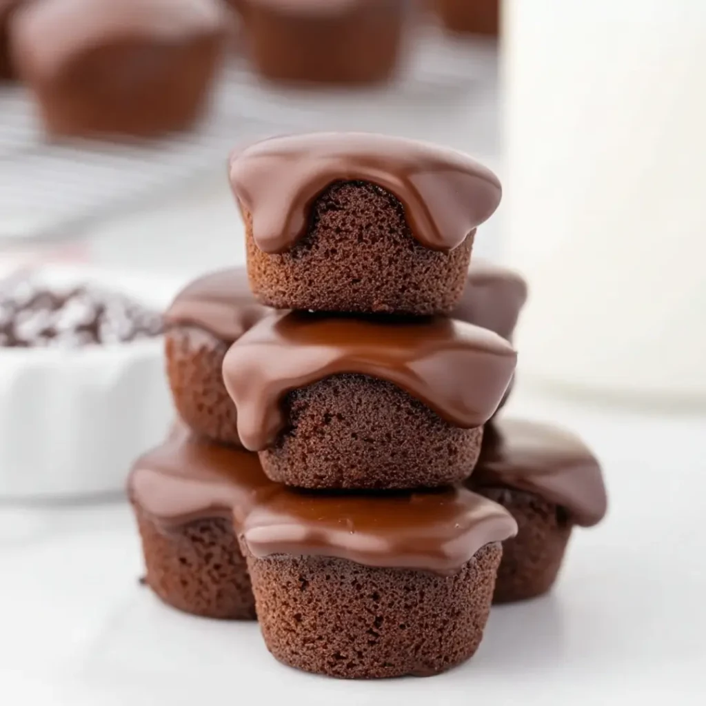 Stack of mini Texas sheet cake bites topped with shiny chocolate glaze