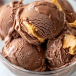 A close-up shot of chocolate peanut butter ice cream in a bowl, highlighting smooth chocolate and peanut butter chunks.