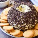 Chocolate chip cheese ball dessert covered in mini chocolate chips and served with cookies