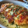 Longhorn Parmesan Crusted Chicken topped with golden cheese and herbs
