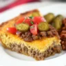 Impossible cheeseburger pie without Bisquick topped with tomatoes and jalapeños