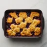 Freshly baked Bisquick blackberry cobbler in a square baking dish