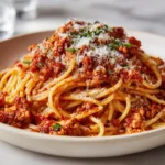 6 large tomatoes 6 cloves garlic, peeled 2 tablespoons olive oil salt & pepper 1 teaspoon dried basil 2 tablespoons olive oil 1 lb. ground turkey 93/7 1 medium onion, diced 2 bay leaves 1 teaspoon dried basil 1 heaping teaspoon Italian seasoning salt & pepper, to taste 1 (15 oz.) can tomato sauce 1 1/2 to 2 tablespoons sugar 1 lb. spaghetti or other pasta