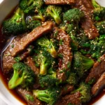 Tender beef and broccoli stir fry with savory garlic ginger sauce, sprinkled with sesame seeds