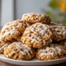 Pumpkin oatmeal cookies made with brown butter and drizzled with sweet vanilla glaze on a plate