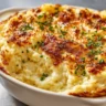 Creamy mashed potato bake topped with golden brown butter crust and fresh herbs