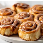 Soft cinnamon rolls swirled with brown sugar and chai-inspired spices, topped with vanilla glaze.
