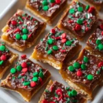 Toffee crackers topped with chocolate and festive red and green sprinkles.