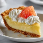 Silky grapefruit cream pie with whipped cream and fresh grapefruit.