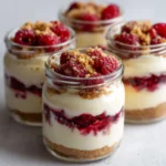 High protein Christmas cheesecake jars with raspberries.