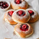 Soft buns filled with raspberry jam and dusted with powdered sugar.