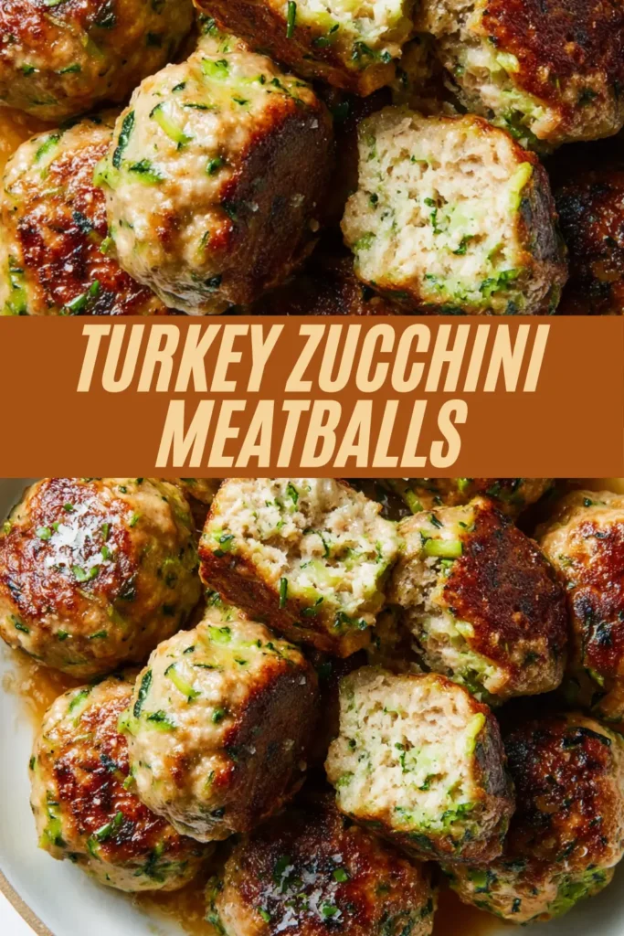 Cluster of turkey zucchini meatballs coated in sauce, cut open to reveal zucchini flecks and browned exteriors