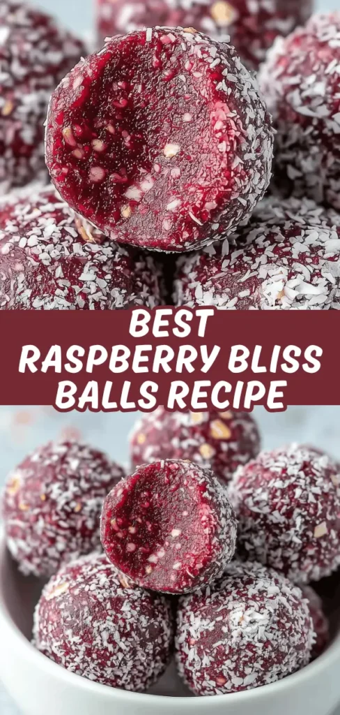 A close-up of a plate filled with vibrant red raspberry bliss balls coated in shredded coconut, with one broken in half to reveal the chewy raspberry filling inside.