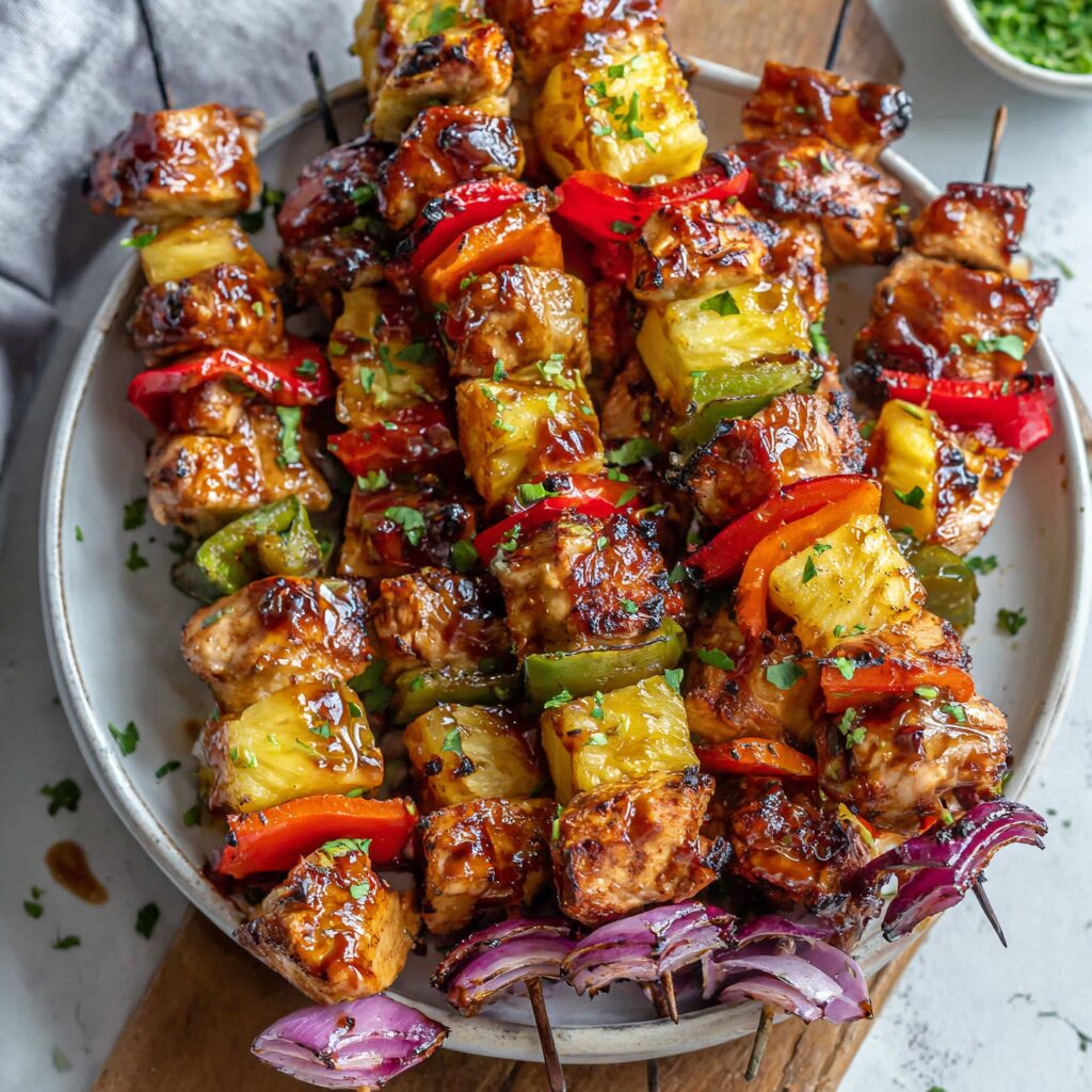 Vibrant skewers of grilled chicken and pineapple offer a sweet and savory delight, perfect for summer grilling.