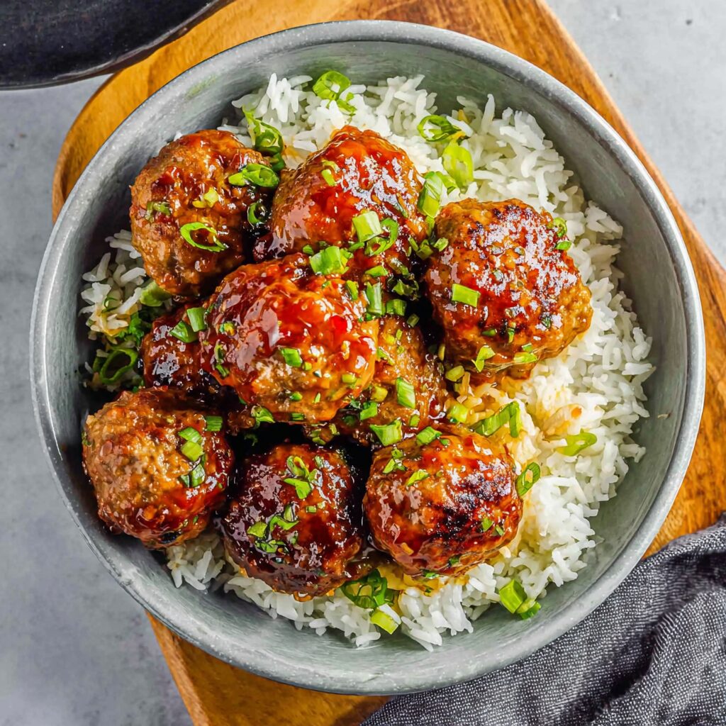 Tantalizing, glistening Korean BBQ meatballs, perfectly browned, promise a delightful explosion of flavor.