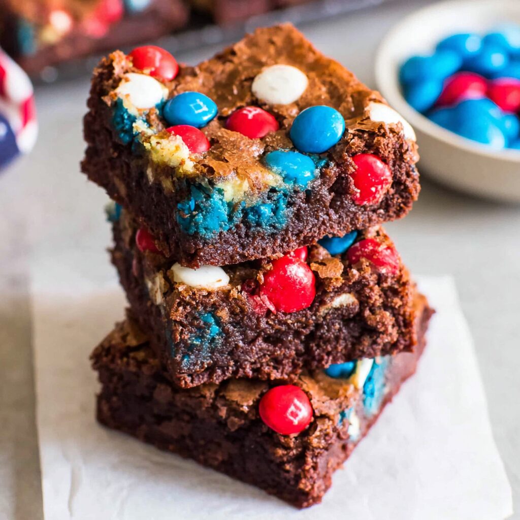 A flag-themed brownie masterpiece, studded with red, white, and blue M&Ms, celebrates a delicious, patriotic dessert.