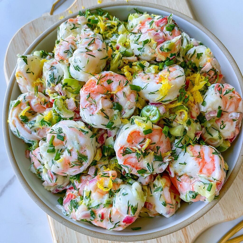 Fresh shrimp salad tossed with zesty lemon and fragrant dill, a vibrant and tasty dish.