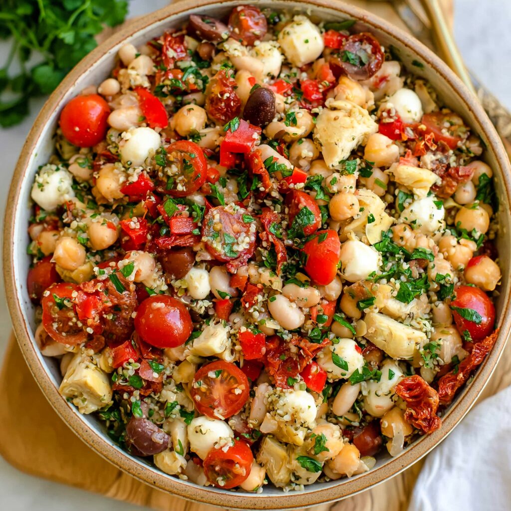A colorful medley of beans, vegetables, and herbs tossed in a zesty dressing, evoking the fresh flavors of the Mediterranean.