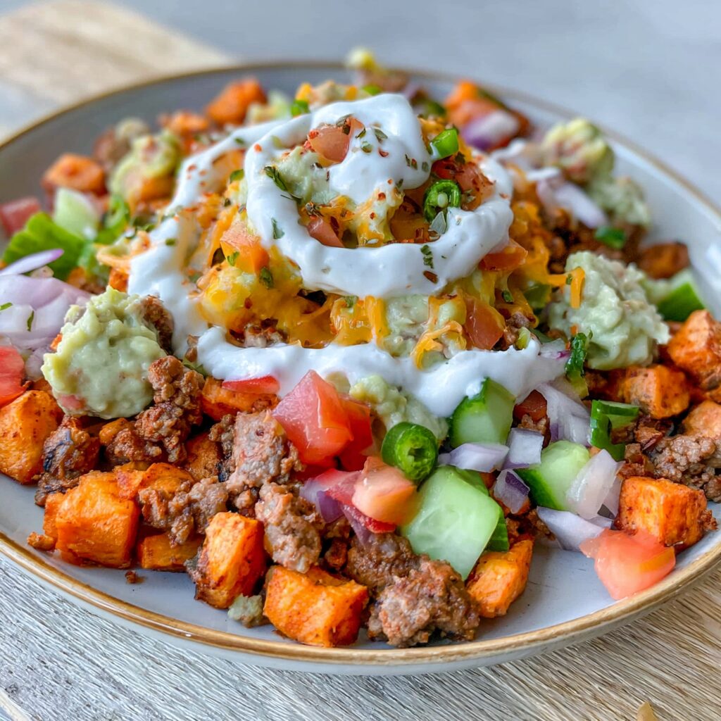 A vibrant sweet potato bowl overflowing with colorful, wholesome toppings, ready to be enjoyed.